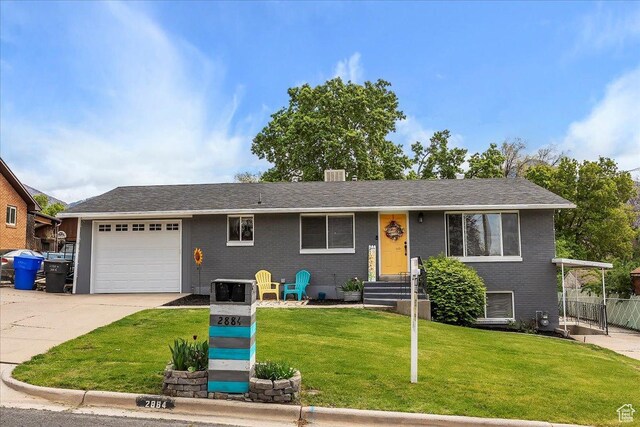 2884 N 300 E, North Ogden, UT 84414 - view of front of house with driveway, brick siding, and a garage