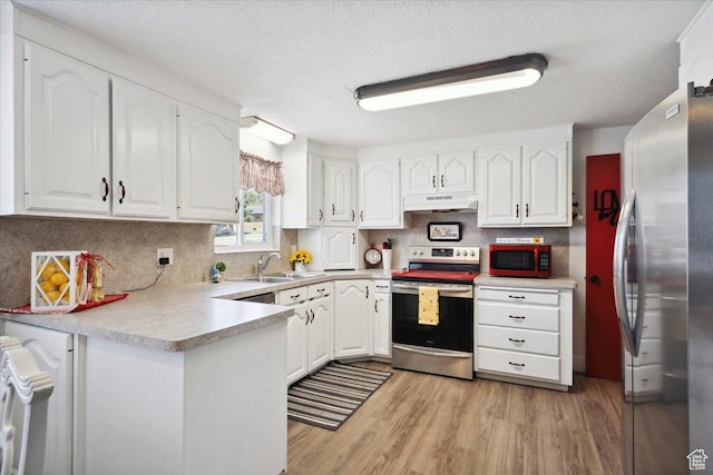 2884 N 300 E, North Ogden, UT 84414 - kitchen with appliances with stainless steel finishes, under cabinet range hood, a sink, a peninsula, and white cabinetry