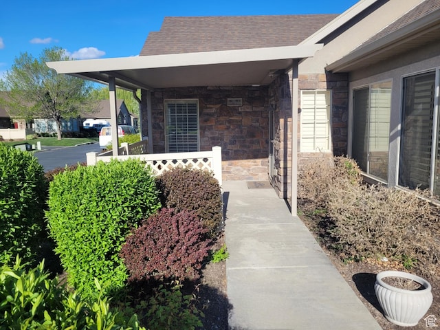 186 S 1900 W Unit R2, Lehi, UT 84043 - view of home's exterior featuring a porch, stone siding, and roof with shingles