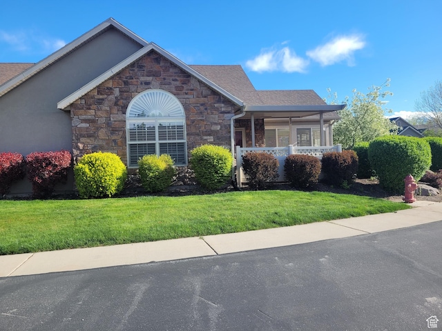 186 S 1900 W Unit R2, Lehi, UT 84043 - view of front of home featuring stone siding, a front yard, and covered porch