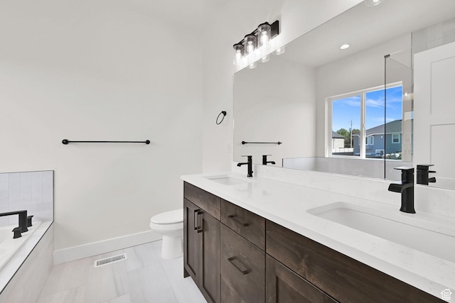 1765 W 650 S, Marriott Slaterville, UT 84404 - bathroom with double vanity, baseboards, a bath, toilet, and recessed lighting