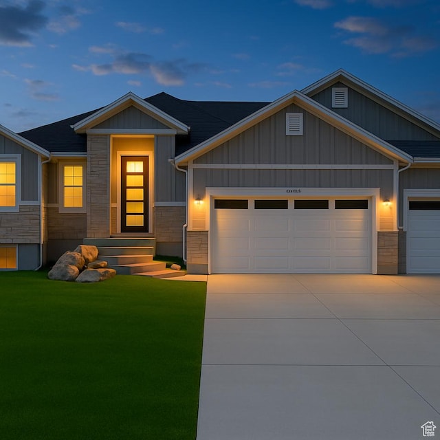 1765 W 650 S, Marriott Slaterville, UT 84404 - view of front of home with a garage, board and batten siding, a yard, and stone siding