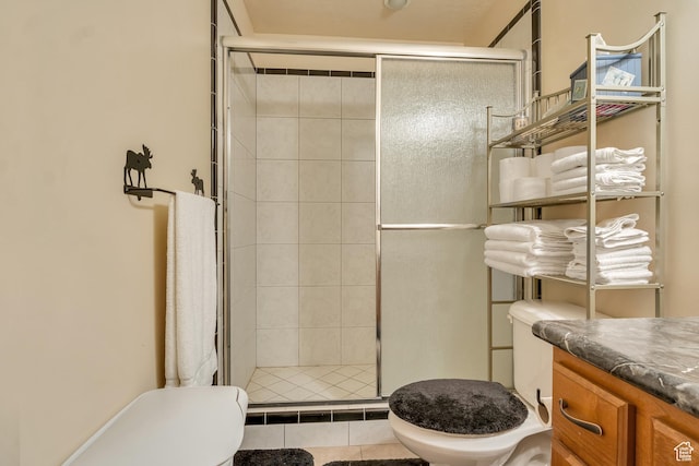 bathroom featuring toilet, a shower stall, and vanity