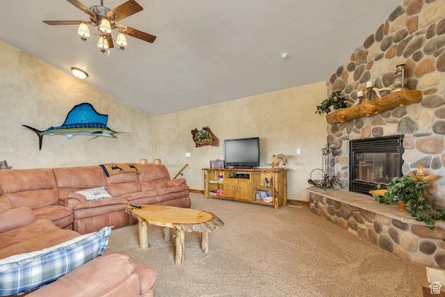 living room with carpet floors, ceiling fan, vaulted ceiling, a fireplace, and baseboards