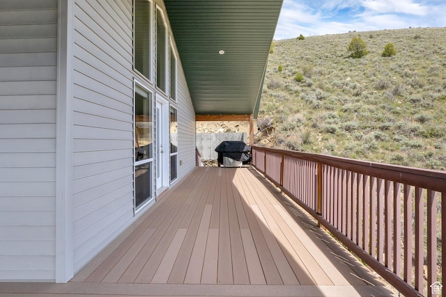 wooden terrace featuring area for grilling