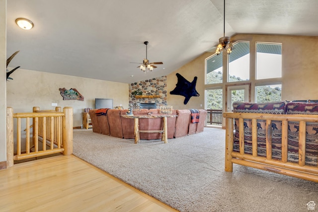 living area with ceiling fan, wood finished floors, and high vaulted ceiling