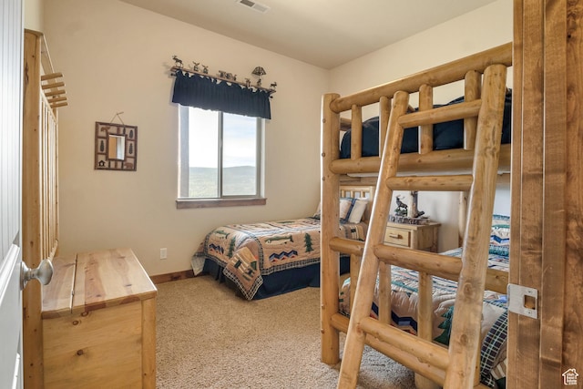 carpeted bedroom featuring baseboards