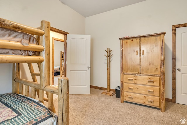 bedroom featuring light carpet and baseboards