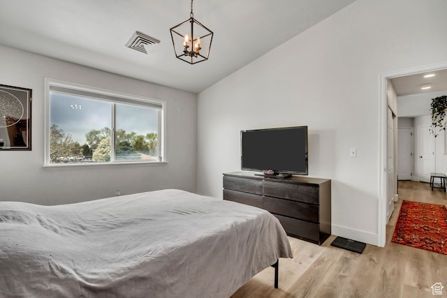 3860 S Mccall St E Unit 3C, Salt Lake City, UT 84115 - bedroom featuring a chandelier, light wood-style floors, lofted ceiling, and baseboards