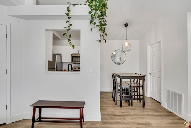 3860 S Mccall St E Unit 3C, Salt Lake City, UT 84115 - dining room with light wood-type flooring and baseboards