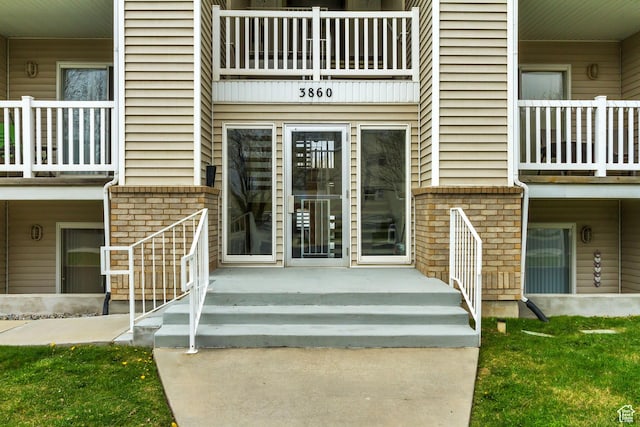 3860 S Mccall St E Unit 3C, Salt Lake City, UT 84115 - view of exterior entry featuring brick siding and a balcony