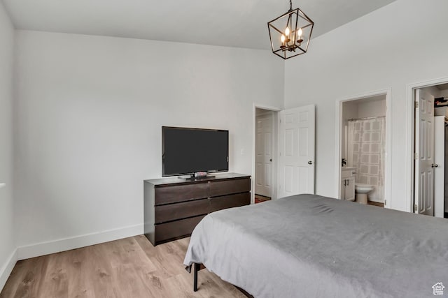3860 S Mccall St E Unit 3C, Salt Lake City, UT 84115 - bedroom with baseboards, a chandelier, light wood-type flooring, connected bathroom, and a towering ceiling