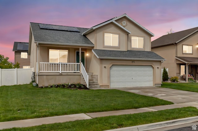 2012 S 575 W, Lehi, UT 84043 - view of front facade with stucco siding, covered porch, roof mounted solar panels, roof with shingles, and an attached garage