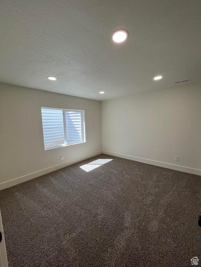 carpeted spare room featuring baseboards and recessed lighting