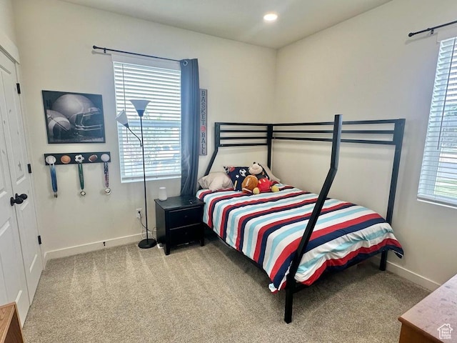 bedroom featuring carpet floors and baseboards