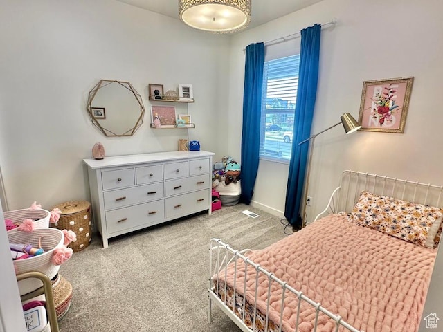 bedroom featuring light colored carpet and baseboards