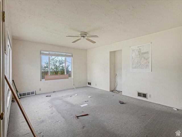 carpeted spare room featuring a ceiling fan