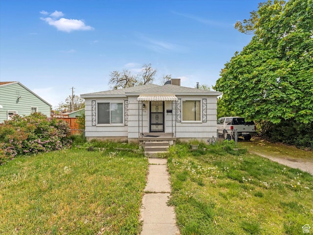 bungalow-style house featuring a front yard