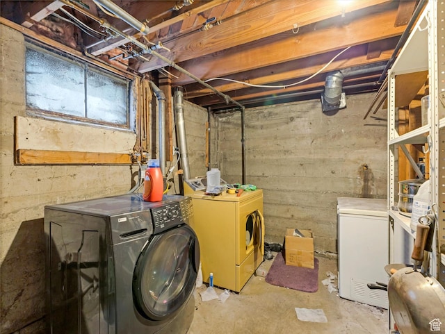 clothes washing area featuring independent washer and dryer