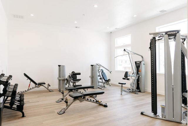 gym featuring wood finished floors, recessed lighting, and baseboards