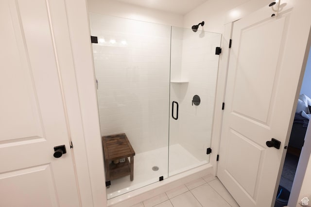 full bath featuring a shower stall and tile patterned flooring