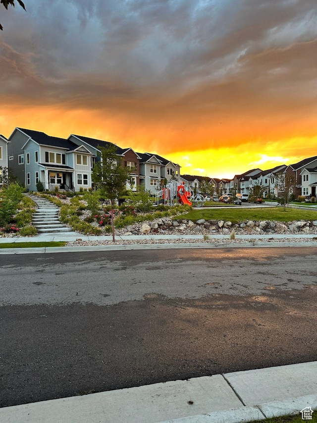 view of asphalt street with a residential view and sidewalks