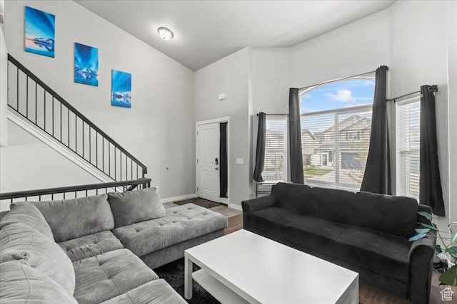 971 W Farnham Dr, North Salt Lake, UT 84054 - living room featuring a towering ceiling, stairway, wood finished floors, and baseboards