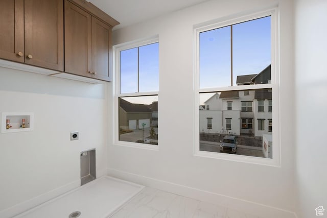 11419 S Watercourse Rd Unit 188, South Jordan, UT 84009 - laundry area with electric dryer hookup, cabinet space, washer hookup, marble look tiles, and baseboards