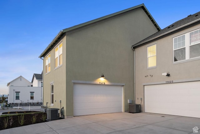 11419 S Watercourse Rd Unit 188, South Jordan, UT 84009 - view of side of home featuring an attached garage, stucco siding, driveway, and central air condition unit