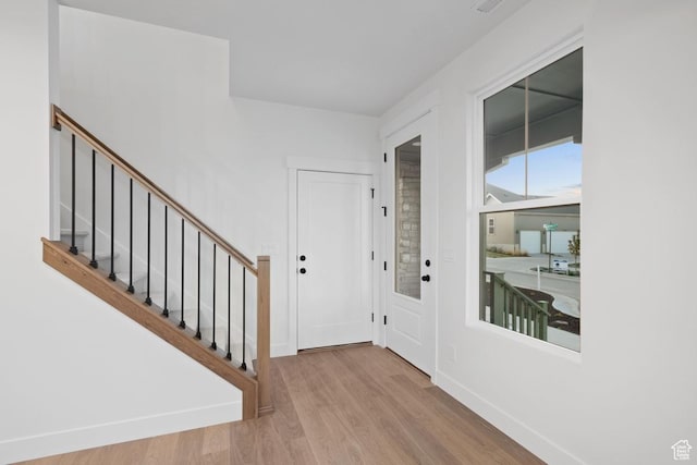 11419 S Watercourse Rd Unit 188, South Jordan, UT 84009 - foyer entrance with wood finished floors, stairway, and baseboards