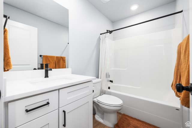 bathroom with toilet, vanity, shower / bath combo with shower curtain, recessed lighting, and wood finished floors