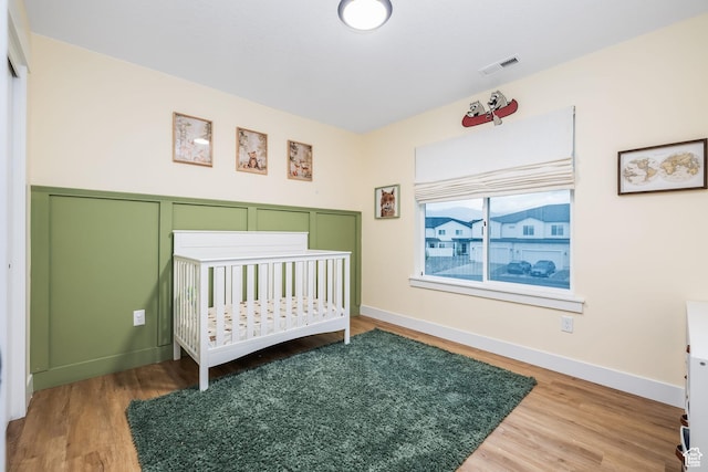 bedroom with wood finished floors and baseboards