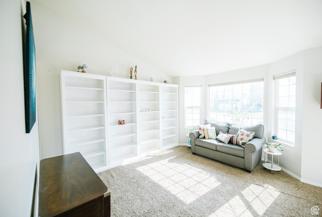 sitting room with plenty of natural light, carpet, vaulted ceiling, and baseboards
