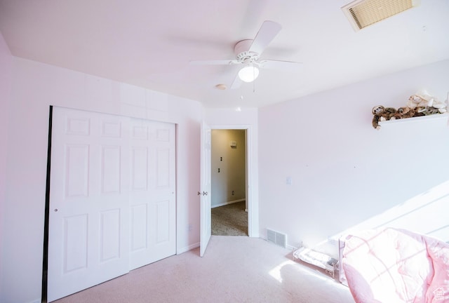 carpeted bedroom with a closet, a ceiling fan, and baseboards