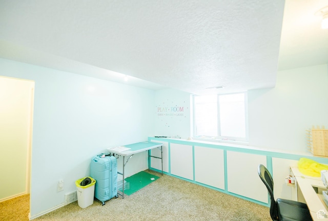 unfurnished office featuring carpet flooring and a textured ceiling