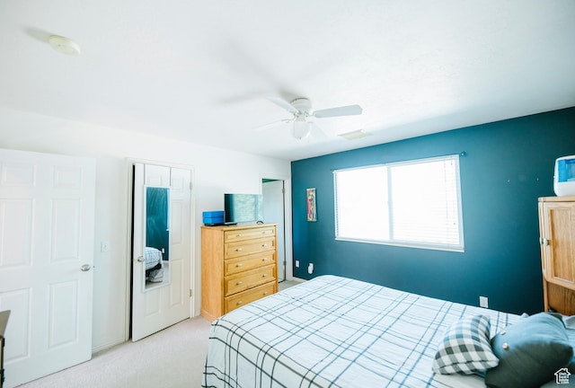 bedroom featuring light colored carpet and ceiling fan