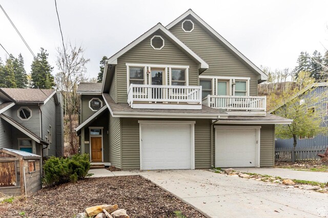 121 Daly Ave, Park City, UT 84060 - view of front of house featuring a balcony, fence, a garage, and concrete driveway
