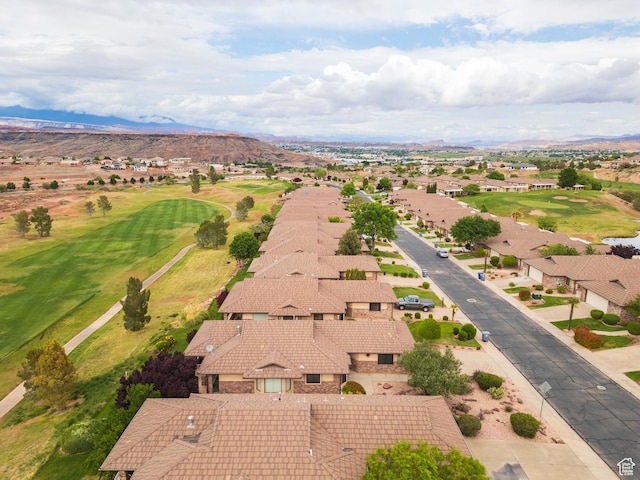 aerial perspective of suburban area featuring a mountainous background and a local golf course