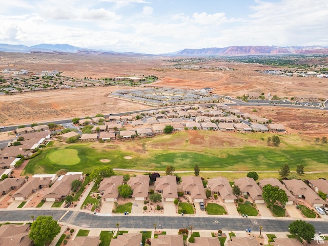 aerial overview of property's location with nearby suburban area and a mountainous background