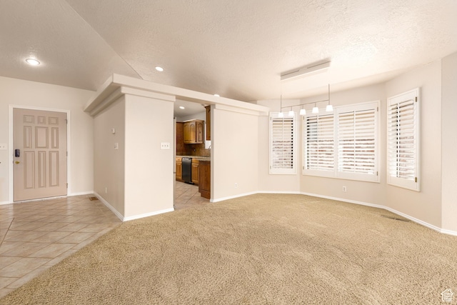 spare room with light carpet, a textured ceiling, recessed lighting, baseboards, and light tile patterned flooring