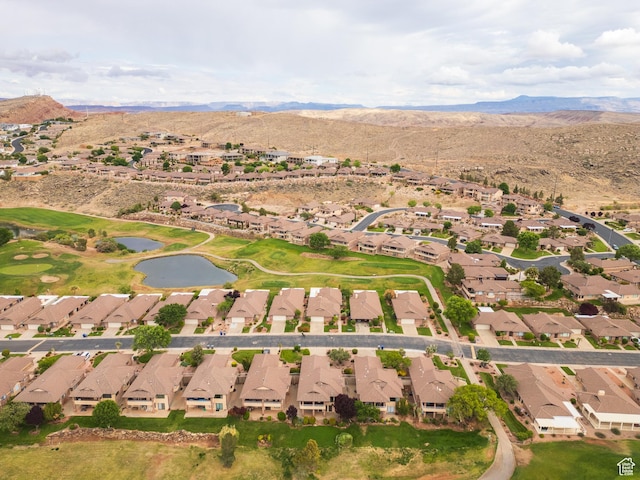 aerial view of property and surrounding area with nearby suburban area and a water and mountain view
