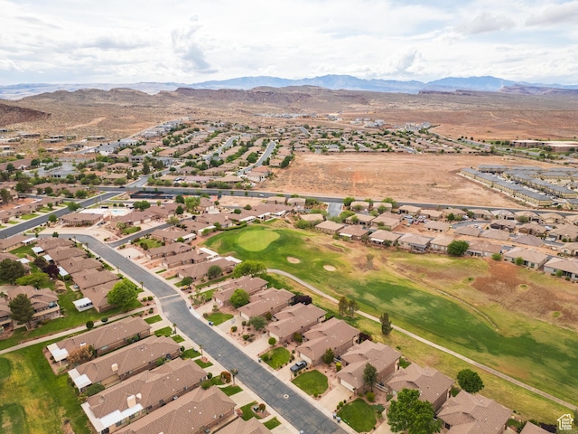 aerial view of property and surrounding area with nearby suburban area and a mountainous background