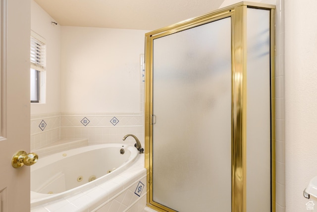 full bath featuring a tub with jets and a stall shower