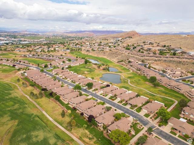 aerial view of property and surrounding area featuring a water and mountain view and nearby suburban area
