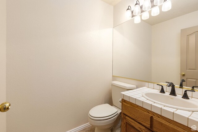 half bath featuring toilet and vanity