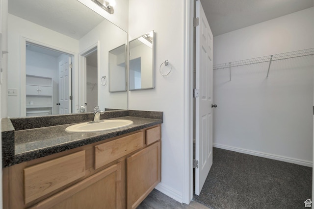 14034 S Sonora Way, Bluffdale, UT 84065 - bathroom with a spacious closet, vanity, and baseboards