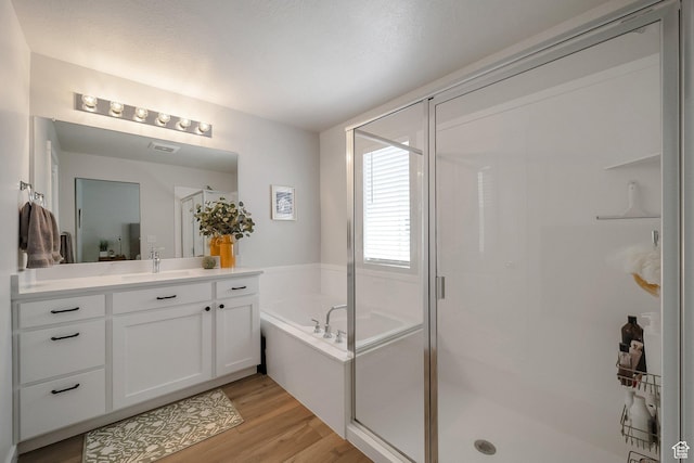 983 W 540 S, American Fork, UT 84003 - bathroom featuring a shower stall, wood finished floors, a garden tub, and vanity