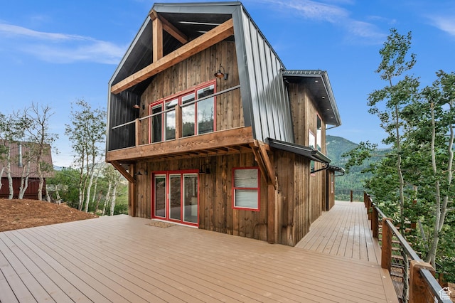rear view of property with a deck with mountain view