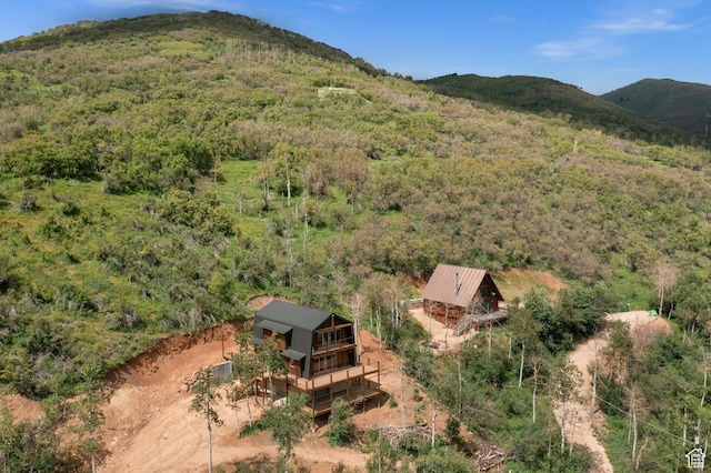 view from above of property featuring a forest and a mountainous background