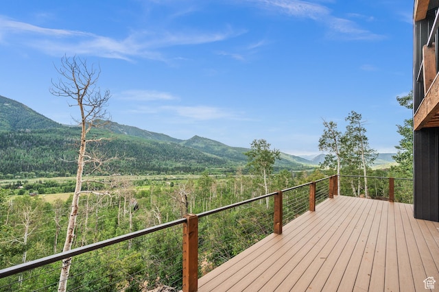 wooden deck with a mountain view